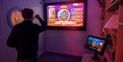 Friends playing augmented Reality Darts at Richardson's Family Entertainment Centre