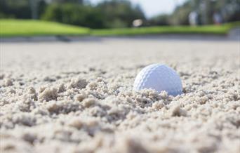 Golf ball in sand